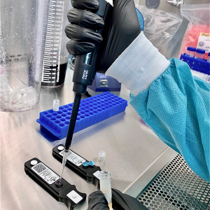 gloved hand uses autopipetter to insert sample in a lightdeck assay
